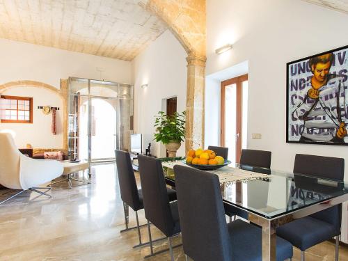 a dining room with a glass table and chairs at Town House Esglesia in Alcudia in Alcudia