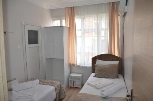 a small bedroom with a bed and a window at TABRİZ HOTEL in Istanbul
