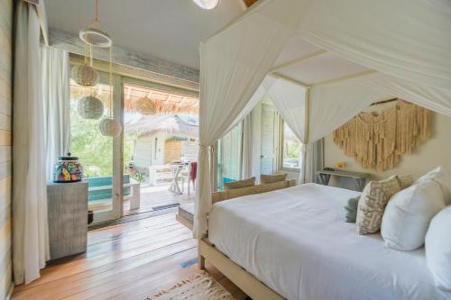 a bedroom with a bed with a canopy at Kai Tulum in Tulum