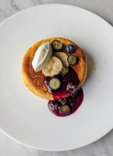 a plate with a pancake with fruit and nuts at Nobu Hotel London Portman Square in London