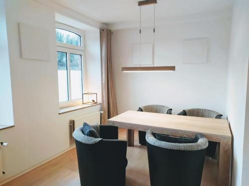 a dining room with a table and chairs at Super Wohnungen #2, #3 und #4 DG im Zentrum, Süd-Sonne und Burg-Blick in Stolberg