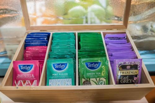 a wooden box filled with different colored ribbons at Holiday Inn Manchester West by IHG in Manchester