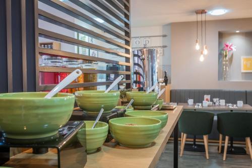a kitchen counter filled with bowls and bowls of food at Holiday Inn Manchester West, an IHG Hotel in Manchester