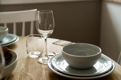 a table with a bowl and a glass of wine at Courtyard at Crail in Crail