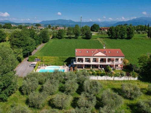 an aerial view of a large house with a swimming pool at Residence Il Fiore Del Garda in Manerba del Garda