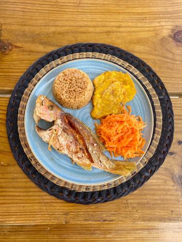 a plate of food with fish and eggs on a table at Hostel Santa Cruz del Islote in Santa Cruz del Islote