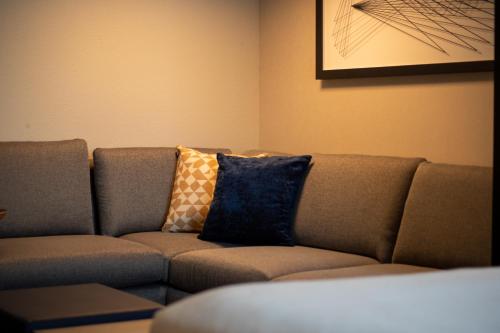 a couch with pillows sitting in a living room at Hyatt Place Altoona/Des Moines in Altoona