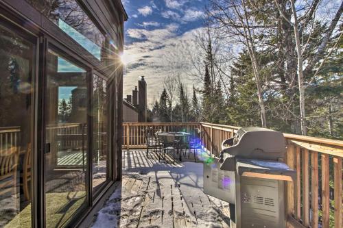 a snow covered porch with a grill on a deck at Lutsen Mountain Townhome - 2 Mi to Lake Superior! in Lutsen