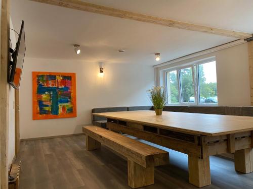 a dining room with a wooden table and benches at Fitters' accommodation near Dresden - comfortable beds, only men, free WLAN & parking spaces, also for trucks in Radeberg