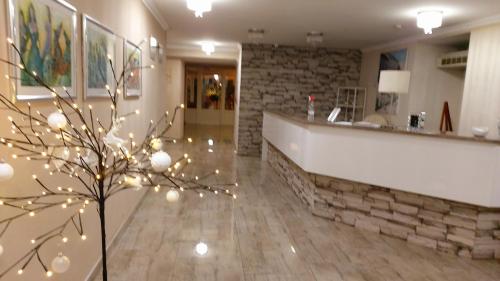 a mall lobby with a christmas tree in the middle at Hotel Admiral in Vinkovci