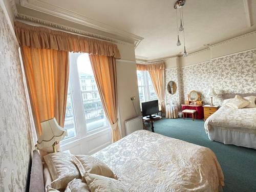 a bedroom with a bed and a large window at White Court Llandudno in Llandudno