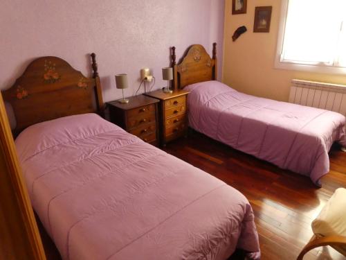 a bedroom with two beds and a dresser at Apartamento Binies in Isaba