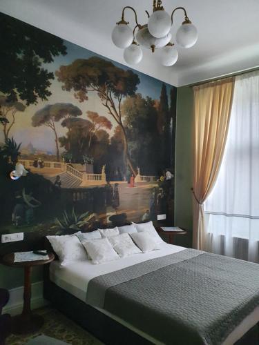 a bedroom with a painting on the wall and a bed at Elisabeth Apartment in Oradea