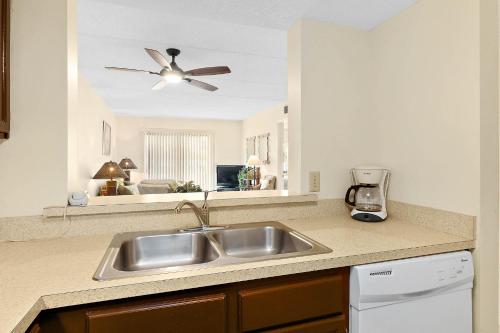 a kitchen with a sink and a ceiling fan at Unit 2105 - Ocean & Racquet Resort in Saint Augustine Beach