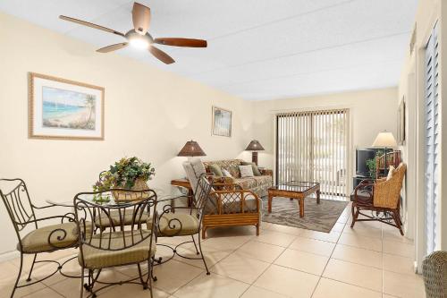 a living room with a couch and a ceiling fan at Unit 2105 - Ocean & Racquet Resort in Saint Augustine Beach