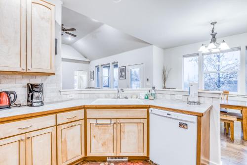 a kitchen with wooden cabinets and a white sink at Scenic View Landing in Walla Walla