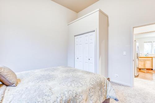 a white bedroom with a bed and a closet at Scenic View Landing in Walla Walla