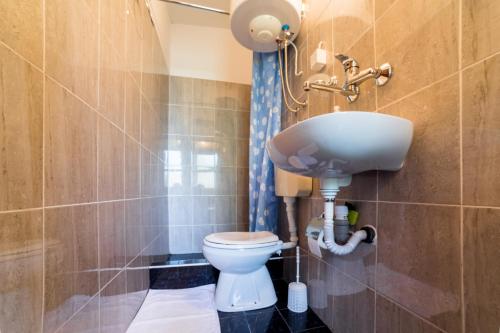 a bathroom with a toilet and a sink at Apartments&Camping ZIP in Kremna