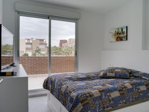 En eller flere senge i et værelse på Vivienda aguas nuevas familiar & deportivo