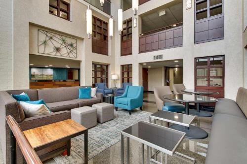 a lobby with couches and tables and chairs at Best Western Plus Indianapolis North at Pyramids in Indianapolis
