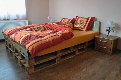 a bedroom with a large bed with a wooden frame at Guest House Eli in Sapareva Banya