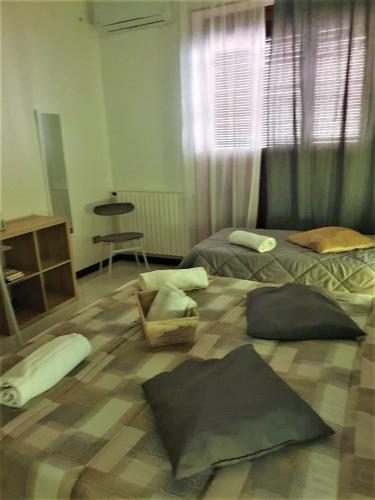 a bedroom with two beds with pillows on the floor at Alba central City in Palermo