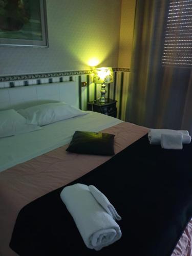 a hotel room with a bed with towels on it at Alba central City in Palermo