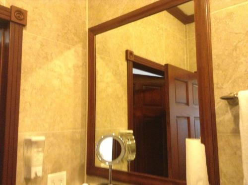 a mirror on the wall of a bathroom at Belizean Nirvana in Placencia Village