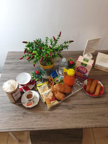 a table with breakfast foods and coffee on it at Alba central City in Palermo
