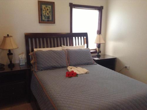 a bedroom with a bed with a stuffed animal on it at Belizean Nirvana in Placencia Village