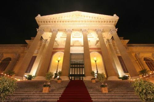 a large white building with stairs in front at Alba central City in Palermo