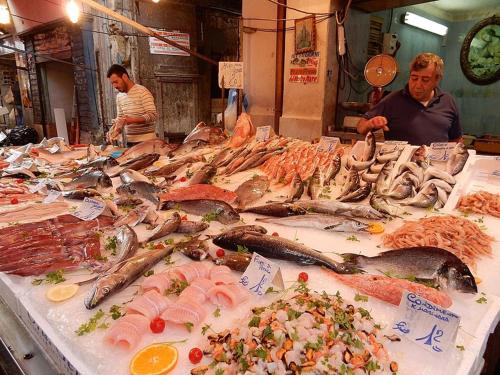 a display of fish on a table in a market at Alba central City in Palermo