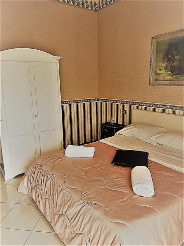 a bedroom with a large bed with two pillows on it at Alba central City in Palermo