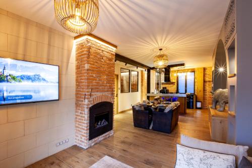 a living room with a fireplace and a tv at OLuxuxy49 - Appartements T3 de prestige, Place du Ralliement, 2ème 3ème et 4ème étage SANS ASCENSEUR in Angers