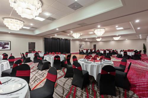 a banquet hall with tables and chairs and chandeliers at Crowne Plaza Silicon Valley North - Union City by IHG in Union City