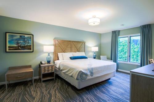 a bedroom with a large bed and a window at The Summit at Massanutten Resort by TripForth in McGaheysville