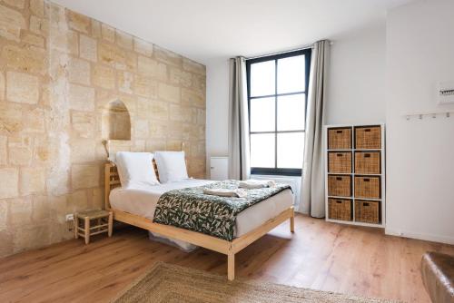 1 dormitorio con cama y ventana grande en Bordeaux Districts, en Le Bouscat