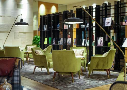 a row of chairs and tables in a library at New World Shenyang Hotel in Shenyang