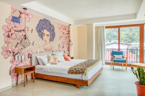a bedroom with a bed and a flower wall at Selina Baños in Baños