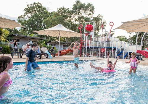 a group of children playing in a swimming pool at Marion Holiday Park in Adelaide
