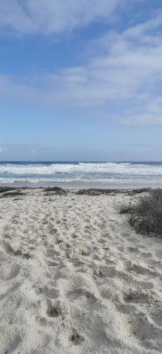 a sandy beach with the ocean in the background at 189 Casa Del Playa in Yzerfontein