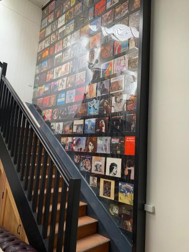 a wall of photos on the side of a staircase at Union Street - Central Castlemaine Pad in Castlemaine