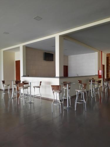 a room with tables and chairs in a building at Flat Quartier Aldeia das Águas in Barra do Piraí