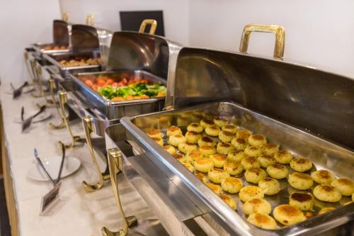 a row of trays of food in a buffet at Landmark Pokhara in Pokhara
