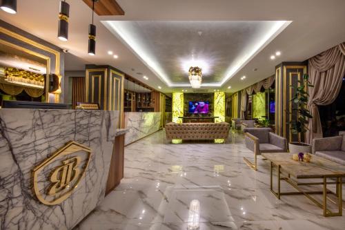 a lobby with a large marble floor and a couch at Mr Beyaz Hotel Sisli Istanbul in Istanbul