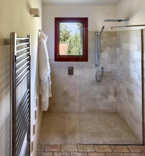 a bathroom with a shower with a glass door at Cascioni Eco Retreat in Arzachena