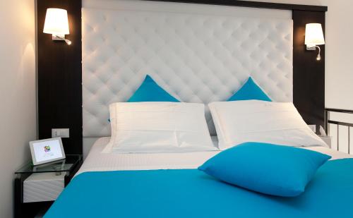 a bedroom with a large bed with blue pillows at Sorrento Flats in Sorrento