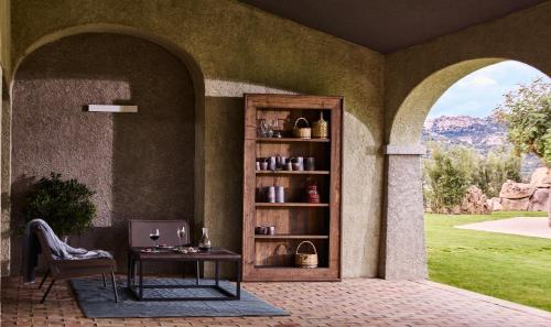 a living room with a table and a book shelf at Cascioni Eco Retreat in Arzachena