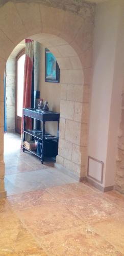 a room with a stone wall and a stone floor at Maison conviviale à Saint-Cybranet avec piscine partagée in Saint-Cybranet