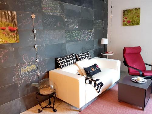 a bedroom with a couch and a wall with graffiti at Modern apartment in Candelaria, 130 m² with shared pool in Candelaria